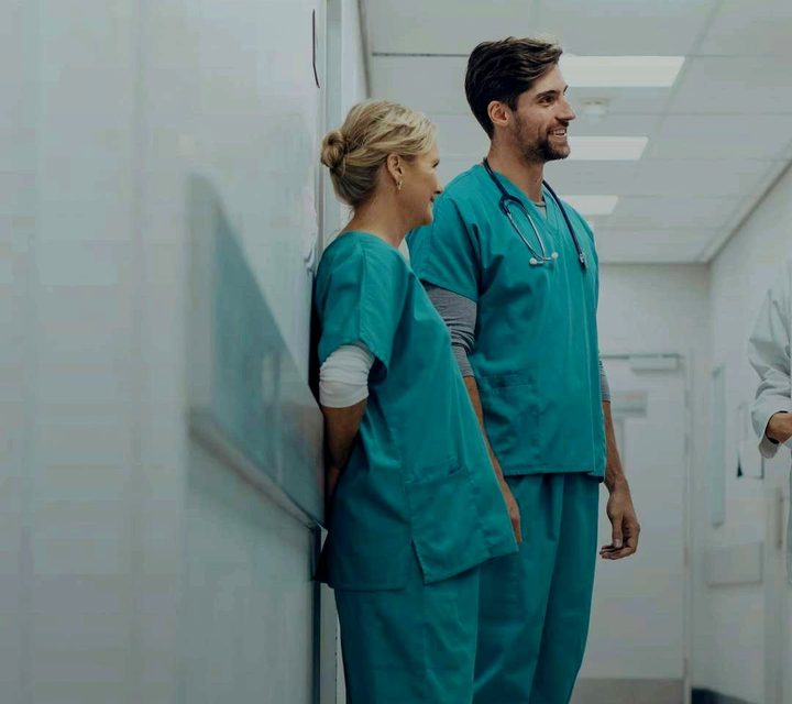 Two nurses standing in a hospital corridor, the still from the lesson’s video